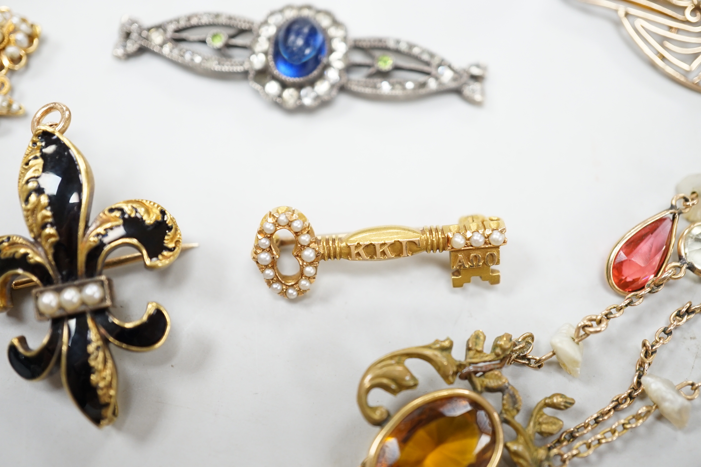 A small group of antique and later jewellery, including 9ct gold and bloodstone fob seal, a 1930's yellow metal and seed pearl set key brooch, 14k and black enamel brooch, spinning fob pendant, coral hand charm, 10k and